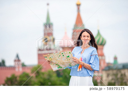 Happy young urban woman in european city. 58970175