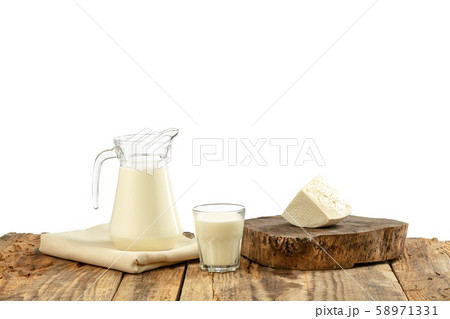 Different milk products, cheese, cream, milk on wooden table and white background. Different milk products, cheese, cream, milk on wooden table and white background. 58971331