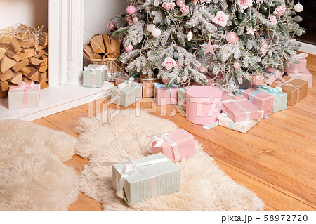 Beautiful Christmas gift boxes on floor near fir Beautiful Christmas gift boxes on floor near fir 58972720