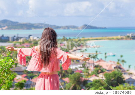 Young tourist woman with view of bay at tropical island in the Caribbean Sea 58974089