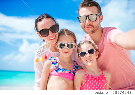 Young beautiful family taking selfie on the beach 58974243