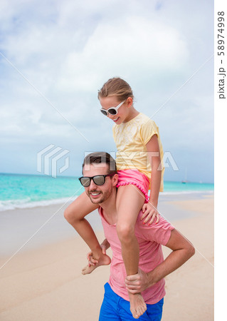 Family of father and sporty little girl having fun on the beach 58974998