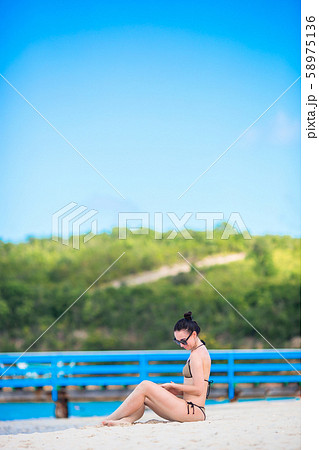 Young fashion woman in swimsuit on the beach Young fashion woman in swimsuit on the beach 58975136