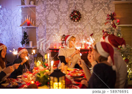 Large happy family celebrating christmas together with delicious meal Large happy family celebrating christmas together with delicious meal 58976691