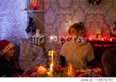 Adult woman dining together with her little daughter at christmas festive dinner Adult woman dining together with her little daughter at christmas festive dinner 58976700