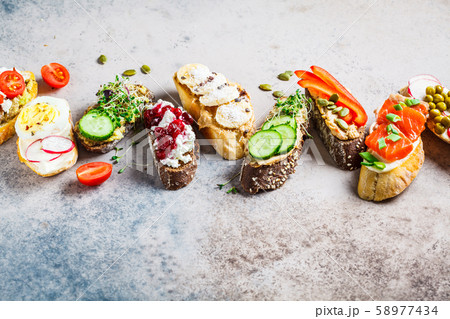 Open toasts with different toppings  58977434