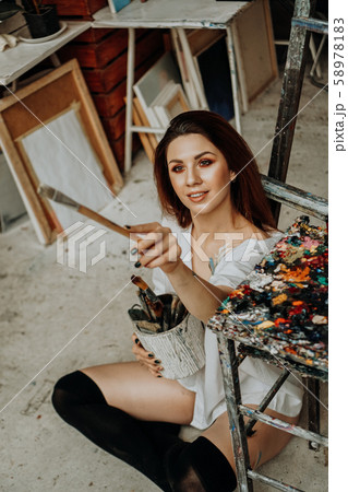 Female artist hand holding paintbrush Female artist hand holding paintbrush 58978183