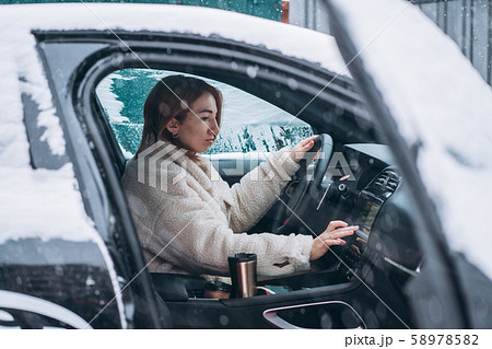 Attractive woman driver nsitting behind the steering wheel in her car 58978582