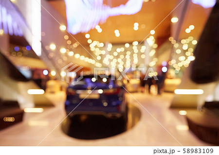 Blurred, defocused background of public event exhibition hall showing cars and automobiles 58983109