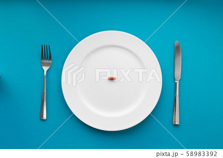 A small tablet in a plate. Medical concept. Eat 58983392