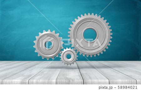 3d rendering of light-grey metal gearwheels on wooden surface on blue wall background. 58984021