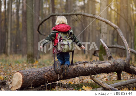 Little boy scout with backpack and rope during hiking Little boy scout with backpack and rope during hiking 58985344