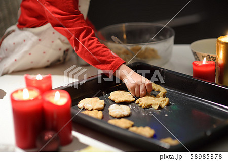 Merry little boy bake cookies during holidays 58985378