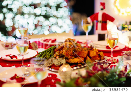Christmas dinner at fire place and Xmas tree. Christmas dinner at fire place and Xmas tree. 58985479