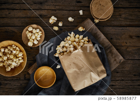 Delicious popcorn with caramel on wooden Delicious popcorn with caramel on wooden 58985877