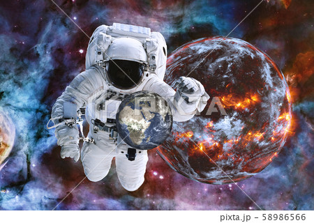 Astronaut near eaxploding planet with earth in Astronaut near eaxploding planet with earth in 58986566