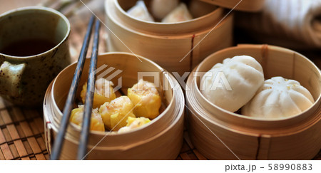 Chinese steamed dumpling and steamed pork bun in a 58990883