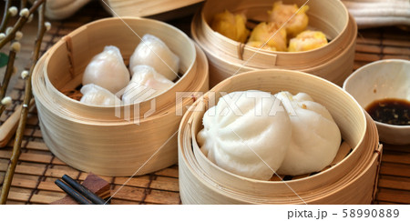 Chinese steamed dumpling and steamed pork bun in a 58990889