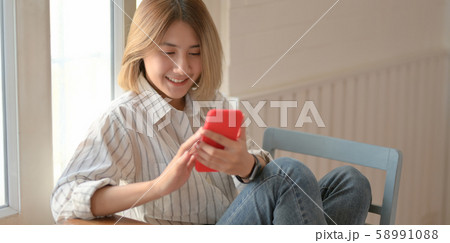Young beautiful female designer looking at Young beautiful female designer looking at 58991088