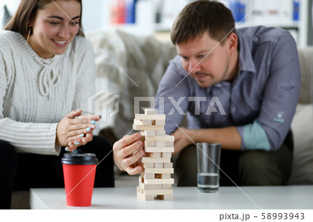 Couple build tower from wood block 58993943