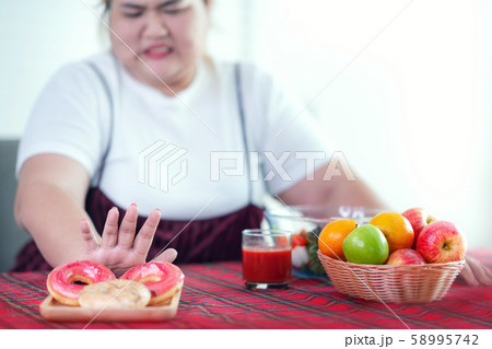 Asian fat girl stop to eat a fat food and junk Asian fat girl stop to eat a fat food and junk 58995742