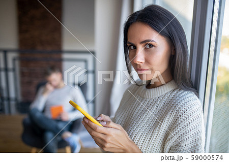 Dark-eyed wife feeling suspicious while feeling jealous 59000574