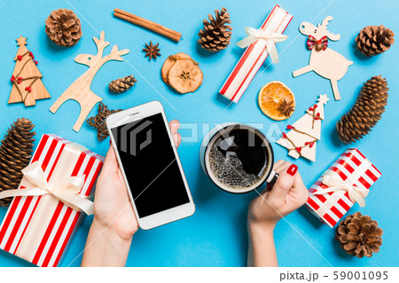 Top view of a woman holding a phone in one hand 59001095