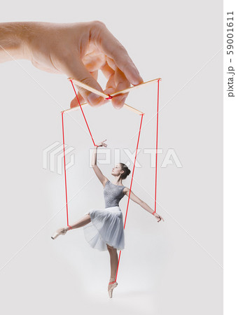 Woman like a puppet in somebodies hands. Concept of manipulation 59001611