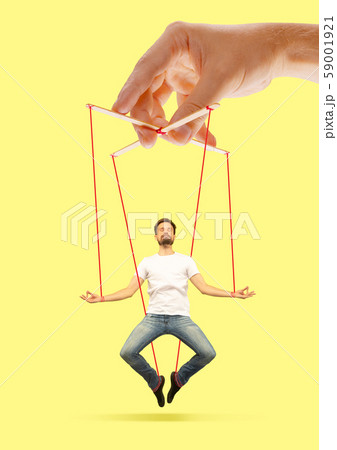Man like a puppet in somebodies hands. Concept of manipulation Man like a puppet in somebodies hands. Concept of manipulation 59001921
