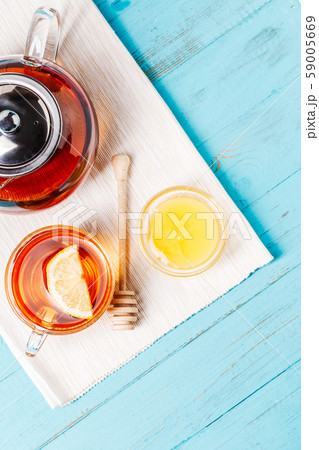 Glass cup of tea with lemon, glass teapot and honey. 59005669