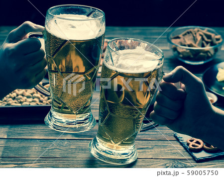 Appetizers and beer on the table for watch the football match. 59005750