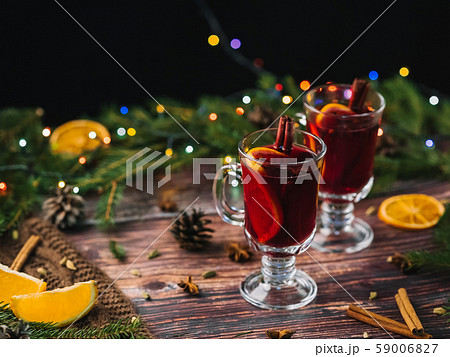mulled wine in glasses on a wooden background with spices and ingredients with Christmas decor mulled wine in glasses on a wooden background with spices and ingredients with Christmas decor 59006827