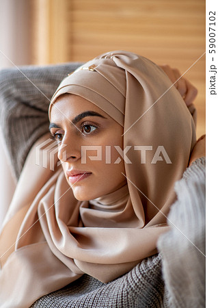 Young Muslim girl dressing up while getting ready for university 59007102