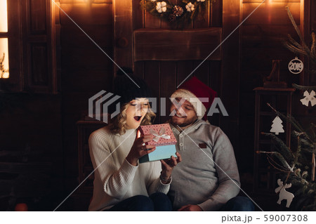 Happy couple under snowfall looking at magical 59007308