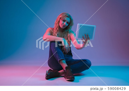 Caucasian young woman's portrait on gradient background in neon light Caucasian young woman's portrait on gradient background in neon light 59008429