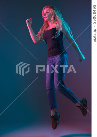 Caucasian young woman's portrait on gradient background in neon light Caucasian young woman's portrait on gradient background in neon light 59008498