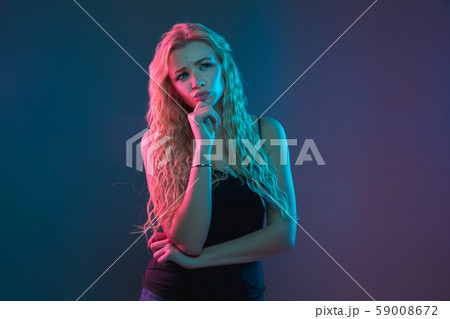 Caucasian young woman's portrait on gradient background in neon light Caucasian young woman's portrait on gradient background in neon light 59008672