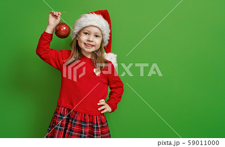girl in Santa hat on color background girl in Santa hat on color background 59011000