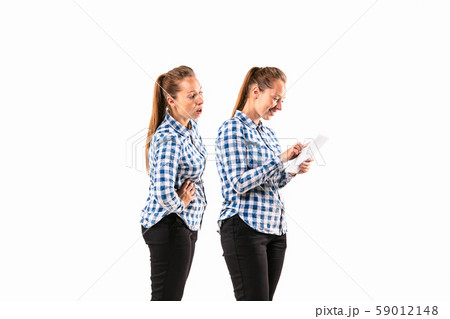 Young handsome woman arguing with herself on white studio background. Young handsome woman arguing with herself on white studio background. 59012148