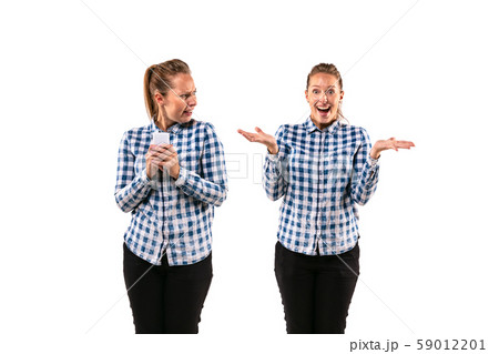 Young handsome woman arguing with herself on white studio background. Young handsome woman arguing with herself on white studio background. 59012201