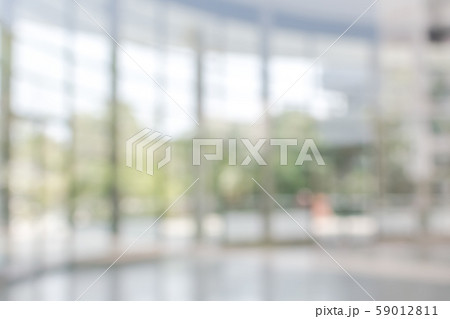 Blur background interior view looking out toward to empty office lobby and entrance doors and glass curtain wall Blur background interior view looking out toward to empty office lobby and entrance doors and glass curtain wall 59012811