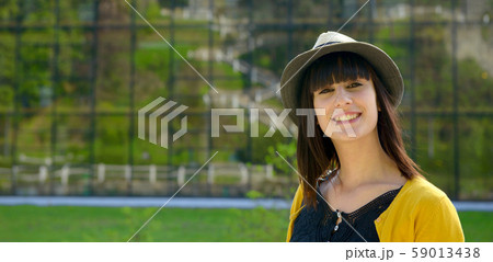 portrait of young brunette girl with summer hat in 59013438