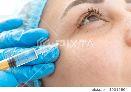 Close-up, beautician makes beauty injections into 59013664