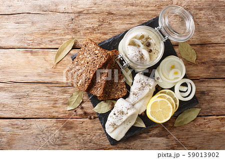 Baltic pickled herring with onions in a glass jar 59013902