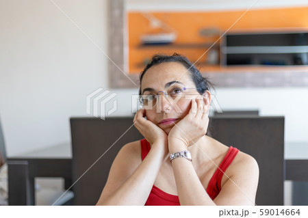 Pretty Spanish woman thinking anything at home Pretty Spanish woman thinking anything at home 59014664