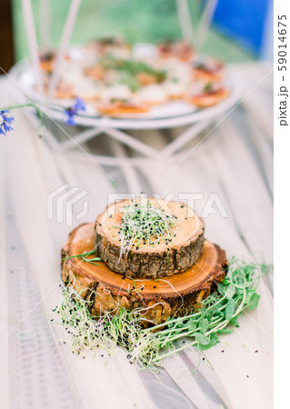 Fresh micro greens on wooden stands plates on the table. Catering service. Restaurant table with 59014675