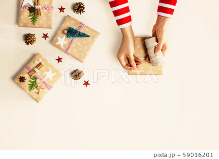 Person making Christmas gift boxes Person making Christmas gift boxes 59016201