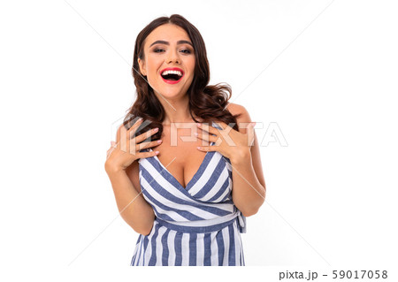 brunette on a white background with a wide smile with teeth laughs and look at the camera brunette on a white background with a wide smile with teeth laughs and look at the camera 59017058