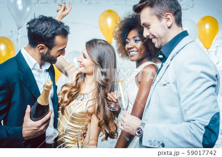 Party people with drinks celebrating new year or a birthday party Party people with drinks celebrating new year or a birthday party 59017742
