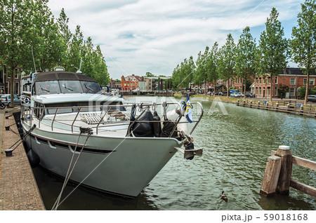 Boat moored on wide canal in the city center of Weesp Boat moored on wide canal in the city center of Weesp 59018168